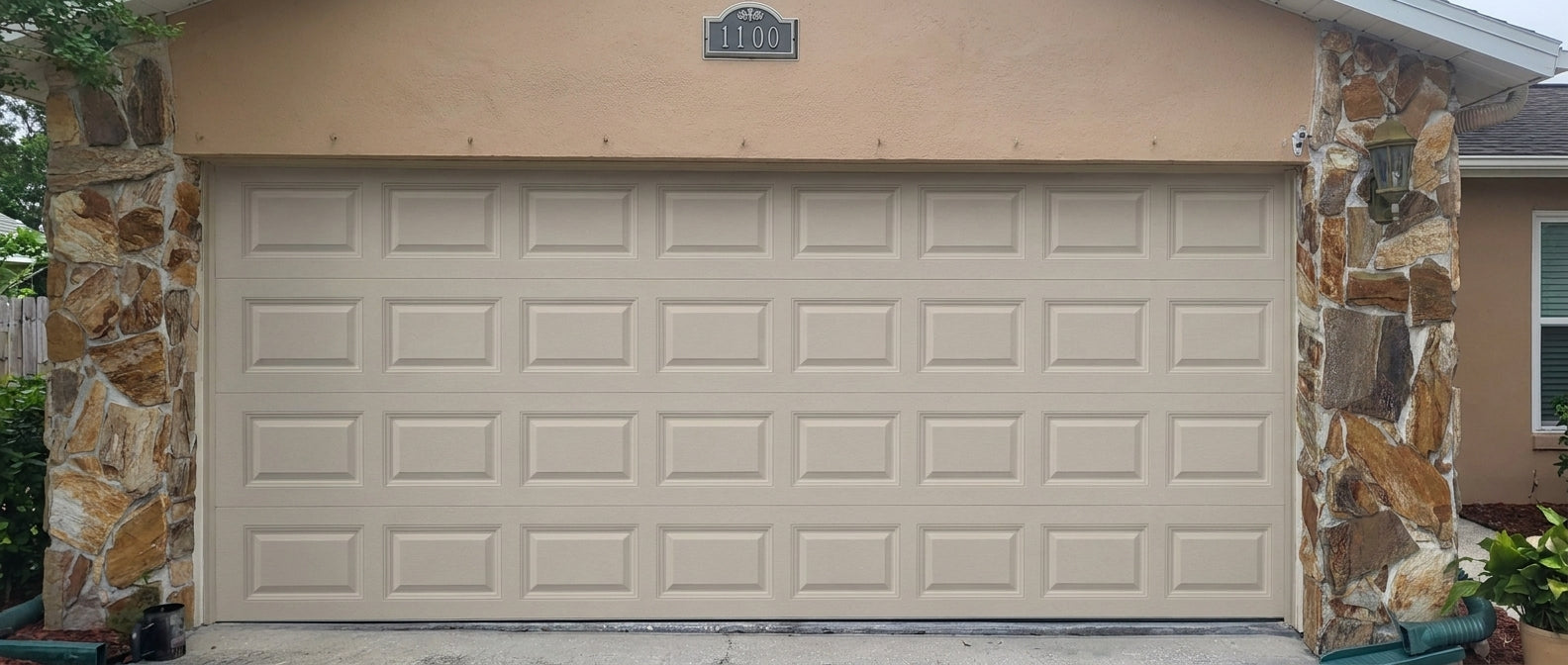 Classic Short Raised Panel - Hurricane Rated in Almond installed on a home (double-car)